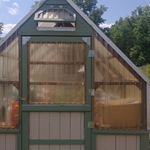 I sanded the greenhouse down to bare wood and then I checked for cracks or holes that needed to be filled in. I then painted the greenhouse a 2 tone color. A tan color for the walls and a green color for the frame of the greenhouse. The project came out great. The customer was very pleased with the outcome.
