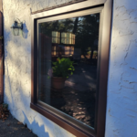 Anderson 100 Series Picture Window with Bronze Exterior/White Interior and Low-e Argon Gas.