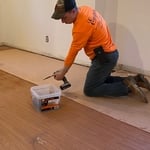 Here we are putting down flooring for an elderly couple we are putting down sheets of paneling down to cover the older floor and laying floating floor down it turned out really nice