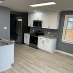 New cabinets, counter tops, laminate flooring and a splash of new paint