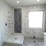 Corner walk in shower and full tiled wall