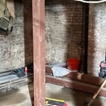 5x5 top anchored steel column with stone and concrete base in the ground