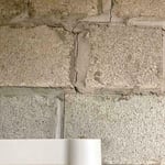 Stair-step cracks on your foundation wall are a common sign of foundation problems caused by settlement and soil issues.