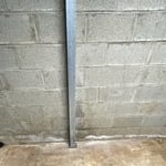 Bottom beam anchored to the floor.