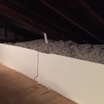 Insulation contained by damming material.