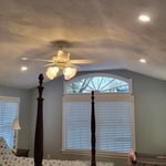 This beautiful bedroom addition only had one switched receptacle to control a bedside lamp! Now they have plenty of light and cool air with their new recessed cans and ceiling fan