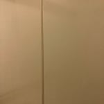 Paint rusty metal partitions in commercial bathrooms