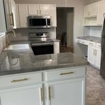 New modern looking kitchen.
Custom gold handles and faucet to match, barn sink, custom epoxy countertop design, white cabinets