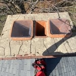 Cracked chimney crown from water damage due to lack of cap.