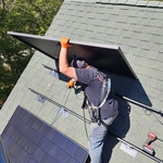 Solar Panels Are Carefully Mounted to the Roof Racking