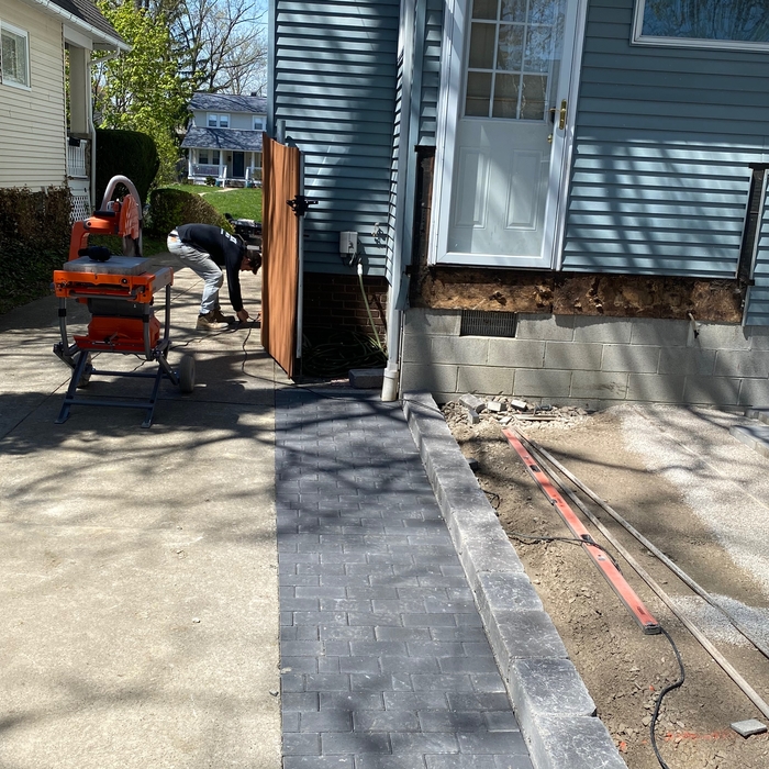 The driveway is cut in and pavers are being laid. This is when we start the back steps up to the house.