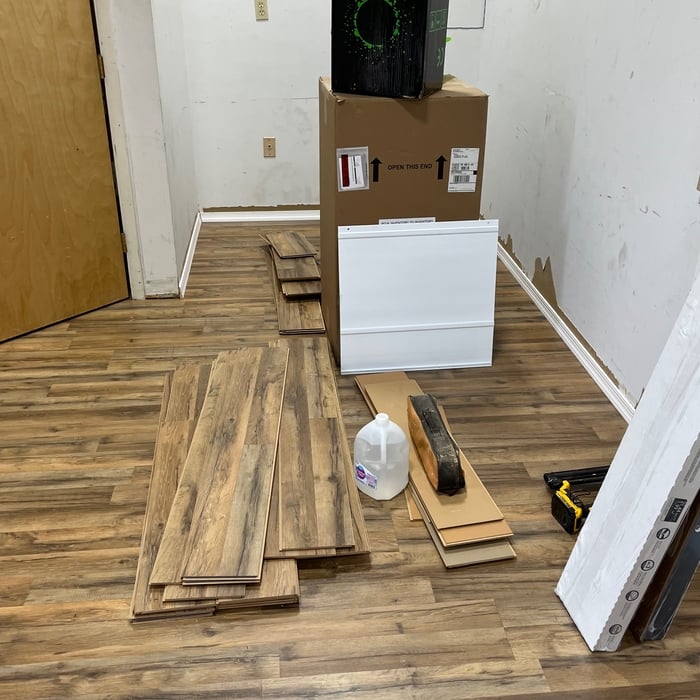 After… newly installed laminate flooring over cement floors in small office.