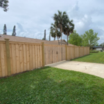 Custom Cedar Board on Board privacy fence with cap facia tops.