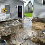 Patio after I soap some of it and started spraying a little showing how dirty it was at the start