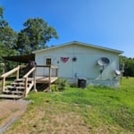 Repainting exterior of a mobile home.