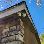 2 cameras mounted on corner of house