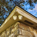 2 cameras mounted on corner of house