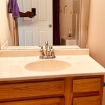 This is a before picture of vanity countertop , mirror & faucet.
