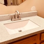 This is another after photo of countertop , faucet and mirror.
