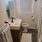 Vanity, bathroom fixtures, and trim work.