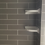 Subway tile shower with corner shelves - we also do custom built corner shelves
