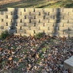 Slope protection retaining wall
