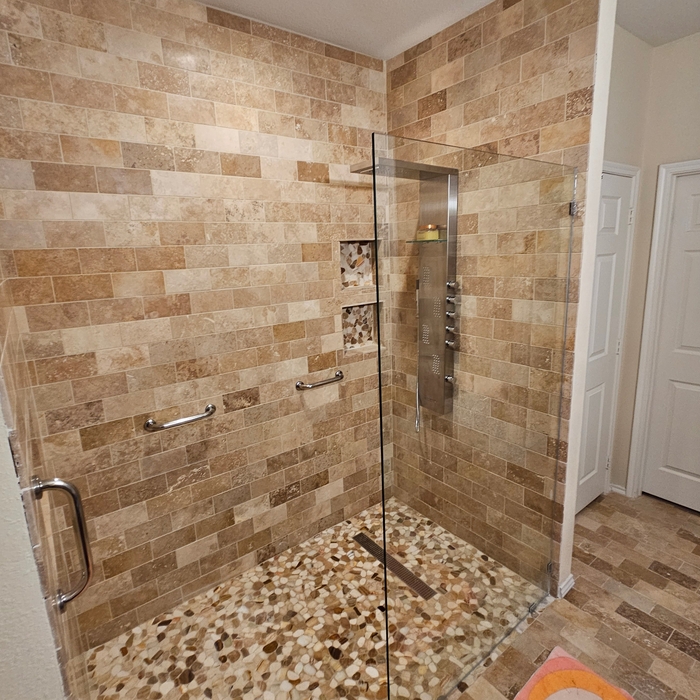 Walk in shower with hand rails and glass panel