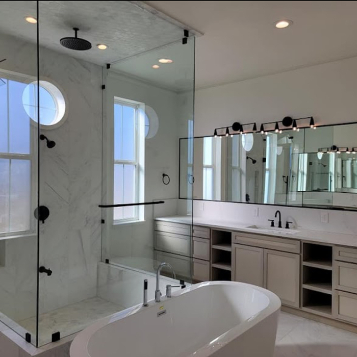 Glass bathroom enclosure w/ three-panel mirrors