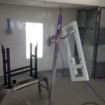 Primed top and painted legs of custom welded stand for plastic shredder