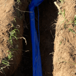 Installation of code approved blue wrapping, with tracer wire on a 1 inch copper water service line.