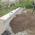 Customer had a retaining wall built and we Backfilled and seeded
