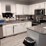 No dirty dishes clean counter tops shiny stove top and silver appliances all shined up and bottles placed where my customer likes everything to be