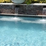 Brick water wall, caped, concrete planters w/ greens