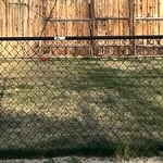 Black chain-link fence install.