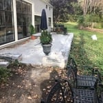 Random pattern bluestone with a two faced stone wall as a retaining boarder.