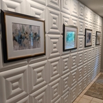 Main entry with a gallery of artwork on leather wall