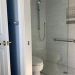 Tub to barrier free shower conversion with custom glass