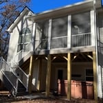 Exterior View of Screened-in Porch with stairs to access back yard of existing house