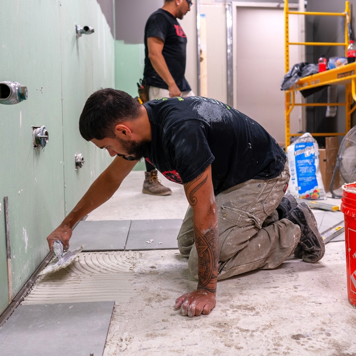 Luciano and JP laying tile