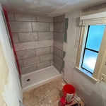 Sheetrock is done and finished, shower has begun waterproof stage and tiles are being put in place