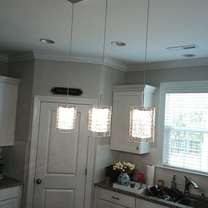Install new pendulum lights over kitchen island