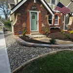 Put rock on the side of the house owner had a lot of weeds there before and build a wall to spread the mulch also giving it a nicer look
