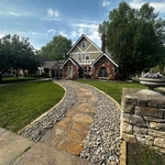 New walkway created with flagstones as well as side beds to complete the look with rock and natural stone as the edging