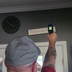 Inspecting the temperature at an air register.