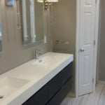 large floating double vanity, lighted mirrors and elegant lighting.