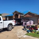 Old shingle and underlayment removed and 2 pieces decking replaced, and new underlayment placed and ready to start nailing shingles.