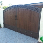 Beautiful Rv gate with stained wood, very durable and Long lasting material. Get a free quote today on amy type of iron work.