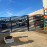 Fence with hinged gate for trucks access.