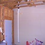When possible, the pipe is run to the garage, and the fan is in the garage attic.