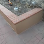 Stucco repair and synthetic color on a flower bed